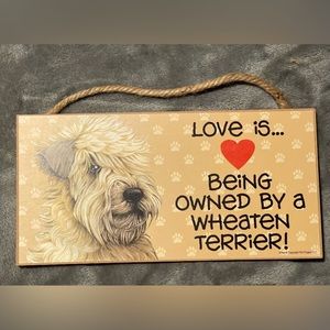 Love is being owned by a Wheaton Terrier.